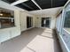 A screened-in porch with lots of windows and sliding glass doors to the inside at 8291 Weeping Willow St, Brooksville, FL 34613