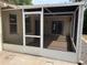 Side view of screened-in porch with sliding doors to the interior at 8291 Weeping Willow St, Brooksville, FL 34613