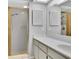 Bathroom featuring a walk-in shower with gold frame, vanity with white cabinets, and large mirror at 9529 Bunker Hill Ct # 9529, New Port Richey, FL 34655
