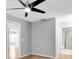 Cozy bedroom with a modern ceiling fan, hardwood floors, and neutral paint at 9529 Bunker Hill Ct # 9529, New Port Richey, FL 34655
