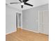 Spacious bedroom with hardwood floors, closet, and modern ceiling fan at 9529 Bunker Hill Ct # 9529, New Port Richey, FL 34655