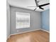 Bright bedroom with hardwood floors, ceiling fan, and ample natural light at 9529 Bunker Hill Ct # 9529, New Port Richey, FL 34655