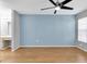 Bedroom featuring wood laminate flooring, a ceiling fan, and a window at 9529 Bunker Hill Ct # 9529, New Port Richey, FL 34655
