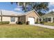 Well-maintained one-story home featuring a garage, manicured lawn and attractive landscaping at 9529 Bunker Hill Ct # 9529, New Port Richey, FL 34655
