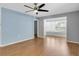 Spacious living room with hardwood floors, a ceiling fan, and plenty of natural light at 9529 Bunker Hill Ct # 9529, New Port Richey, FL 34655