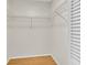 Walk-in closet offers functional, customizable storage with shelving and hardwood floor at 9529 Bunker Hill Ct # 9529, New Port Richey, FL 34655