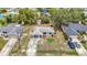 Aerial view of the neighborhood showing the single story home and mature trees at 10139 Carrin Rd, Spring Hill, FL 34608
