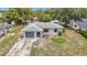 Aerial view of a charming single-story home with a driveway and mature trees at 10139 Carrin Rd, Spring Hill, FL 34608