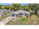 Aerial view of a charming single-story home with a driveway and mature trees at 10139 Carrin Rd, Spring Hill, FL 34608
