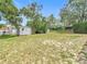 A spacious backyard featuring a storage shed and mature trees for privacy at 10139 Carrin Rd, Spring Hill, FL 34608