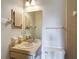 Cozy bathroom featuring a sink, large mirror, and a toilet at 10139 Carrin Rd, Spring Hill, FL 34608