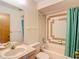 Bathroom featuring tiled shower and bath, vanity, and towel bars at 10139 Carrin Rd, Spring Hill, FL 34608