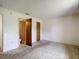 Bedroom with neutral walls, neutral carpeting, wood closets, and attached bathroom at 10139 Carrin Rd, Spring Hill, FL 34608