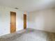 Spacious bedroom with neutral walls, neutral carpeting, and two wood closets at 10139 Carrin Rd, Spring Hill, FL 34608