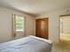 Bedroom featuring neutral walls, carpet floors and a bed with a blanket, window, and closet at 10139 Carrin Rd, Spring Hill, FL 34608