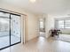 Dining room featuring tile floor, view to the screened patio and living room at 10139 Carrin Rd, Spring Hill, FL 34608