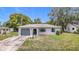 Charming single-story home with a well-maintained front yard and a one car garage at 10139 Carrin Rd, Spring Hill, FL 34608