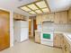 Kitchen featuring laminate counters, white appliances, and eat-in nook at 10139 Carrin Rd, Spring Hill, FL 34608