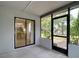 Enclosed lanai with sliding glass door leading to the interior and a door to the outside at 10139 Carrin Rd, Spring Hill, FL 34608