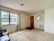 Bright room with large window, carpet, front door and hall closet at 10139 Carrin Rd, Spring Hill, FL 34608