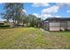 Expansive backyard featuring lush greenery, a screened pool enclosure, and mature trees, perfect for outdoor living at 10277 Rosetti Ct, Spring Hill, FL 34608