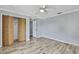 Bright bedroom features wood floors, fan and spacious closet with folding doors at 10277 Rosetti Ct, Spring Hill, FL 34608