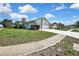 Inviting home exterior with a long driveway and well-maintained lawn, showcasing curb appeal in a desirable neighborhood at 10277 Rosetti Ct, Spring Hill, FL 34608