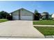 Well-maintained home with a spacious driveway and lush landscaping at 10277 Rosetti Ct, Spring Hill, FL 34608