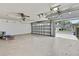 Garage with open door showing the driveway, street and nearby home at 10277 Rosetti Ct, Spring Hill, FL 34608