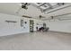 Spacious garage with white walls, ceiling fan, and storage shelves at 10277 Rosetti Ct, Spring Hill, FL 34608