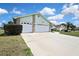 Attached two-car garage featuring paneled doors and brick detailing, seamlessly blending with the home's facade at 10277 Rosetti Ct, Spring Hill, FL 34608