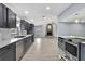Modern kitchen showcases stainless appliances, gray cabinetry, subway tile backsplash and an opening into the living area at 10277 Rosetti Ct, Spring Hill, FL 34608