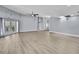 Expansive living area featuring modern floors, lots of natural light, and ceiling fan at 10277 Rosetti Ct, Spring Hill, FL 34608