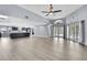 Open living space with modern flooring, kitchen access, ample natural light, and backyard access at 10277 Rosetti Ct, Spring Hill, FL 34608