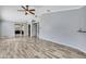 Spacious living room boasts ample natural light, wood flooring, and a ceiling fan at 10277 Rosetti Ct, Spring Hill, FL 34608