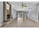 Open living room with a brick fireplace and sliding glass doors to the backyard at 10277 Rosetti Ct, Spring Hill, FL 34608