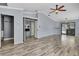 Spacious living room with vaulted ceilings, wood flooring, and sliding glass doors to the pool at 10277 Rosetti Ct, Spring Hill, FL 34608