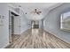 Bright and airy living room featuring wood flooring, vaulted ceilings, and access to the outdoor area at 10277 Rosetti Ct, Spring Hill, FL 34608
