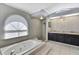 Luxurious main bathroom featuring a garden tub, walk-in shower, and modern fixtures at 10277 Rosetti Ct, Spring Hill, FL 34608