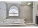 Bathroom featuring a luxurious soaking tub and walk-in shower at 10277 Rosetti Ct, Spring Hill, FL 34608