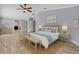 Serene bedroom featuring neutral tones, wood accents, and access to the en-suite bathroom at 10277 Rosetti Ct, Spring Hill, FL 34608