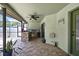 Outdoor kitchen with stone countertop, mini-fridge, and tile floors at 10277 Rosetti Ct, Spring Hill, FL 34608