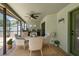 Inviting outdoor patio featuring comfortable wicker seating, a ceiling fan, and a built-in bar area for relaxation at 10277 Rosetti Ct, Spring Hill, FL 34608