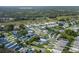 Scenic aerial view of a charming home situated in a lively community with mature trees and manicured green spaces at 1084 Vista Fina Ct, Spring Hill, FL 34608