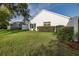 The backyard offers lush green grass and manicured landscaping, enhancing the home's curb appeal at 1084 Vista Fina Ct, Spring Hill, FL 34608