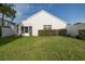 Backyard showcasing the lawn and bushes surrounding the house, providing plenty of curb appeal at 1084 Vista Fina Ct, Spring Hill, FL 34608