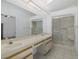 This bathroom has double sinks, a large mirror, and walk-in shower at 1084 Vista Fina Ct, Spring Hill, FL 34608
