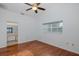 This bedroom offers wood floors, a ceiling fan, and a window with natural light at 1084 Vista Fina Ct, Spring Hill, FL 34608