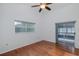 Spacious bedroom with wood flooring, slider to lanai, and a window at 1084 Vista Fina Ct, Spring Hill, FL 34608