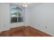 Bedroom with wood floors, large window with blinds and a ceiling fan at 1084 Vista Fina Ct, Spring Hill, FL 34608